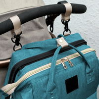 Thumbnail for Nuvella Baby – Aina valmiina – Monikäyttöinen vaippalaukku sängyllä